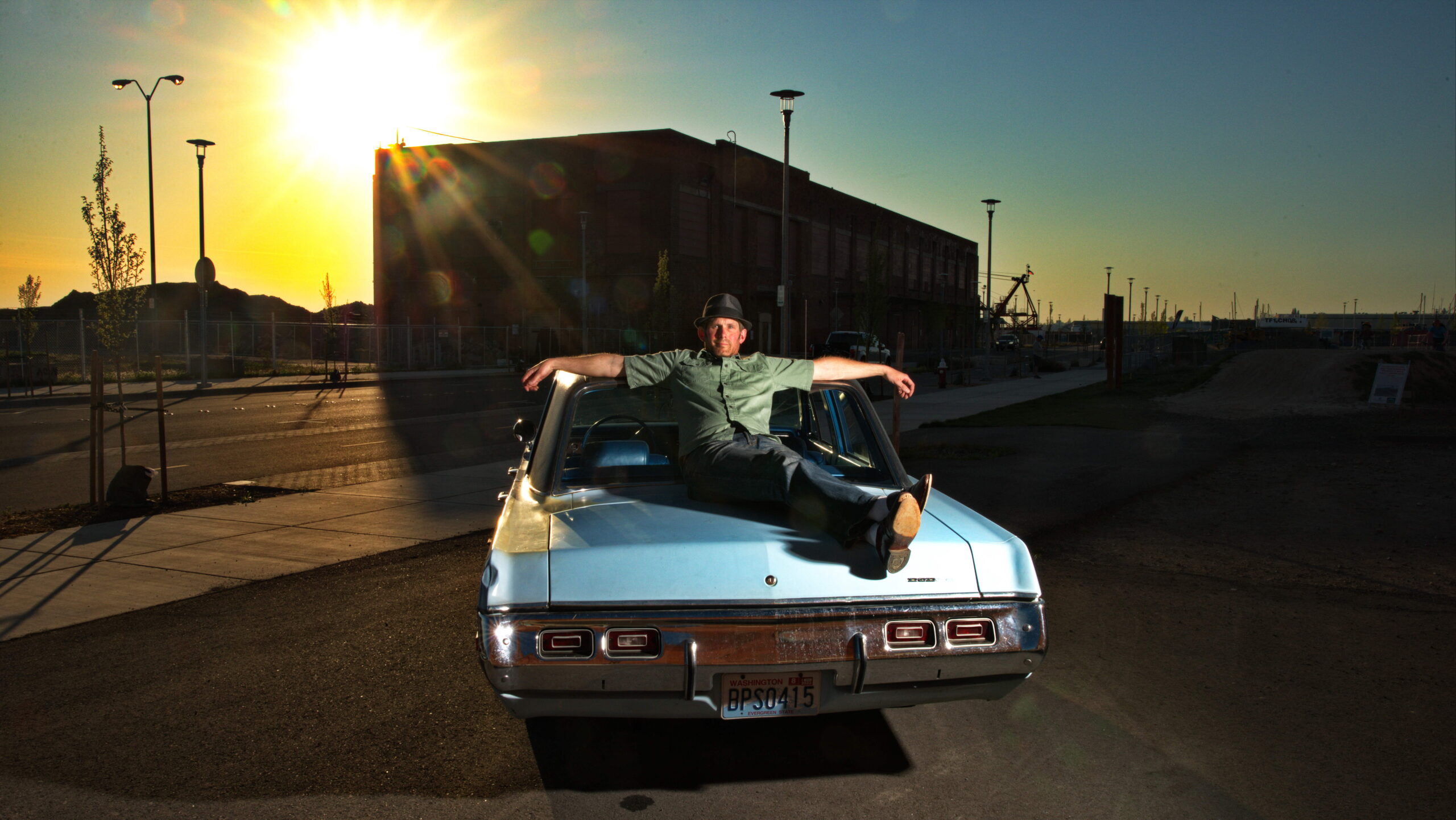 Man on a car with sunset